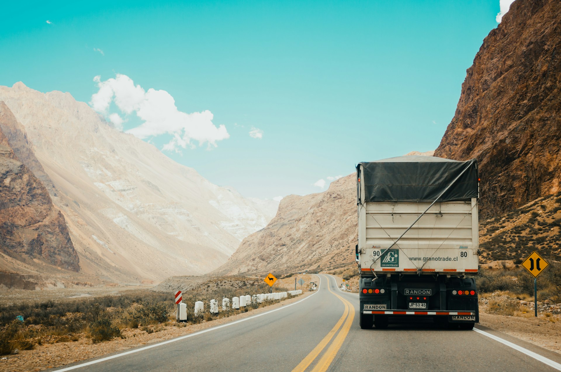 Long-haul trucks lined up at a distribution center during golden hour